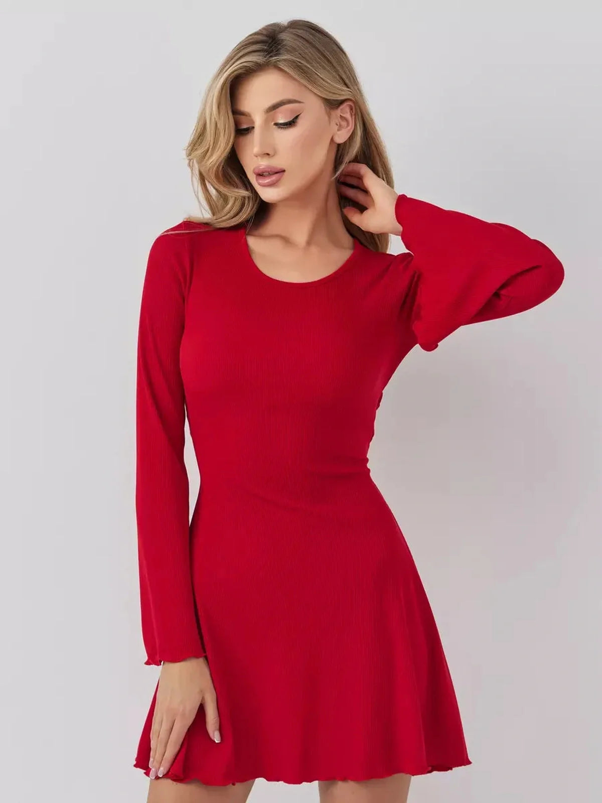 Model in a stylish red mini dress with long sleeves, perfect for summer events and formal occasions.