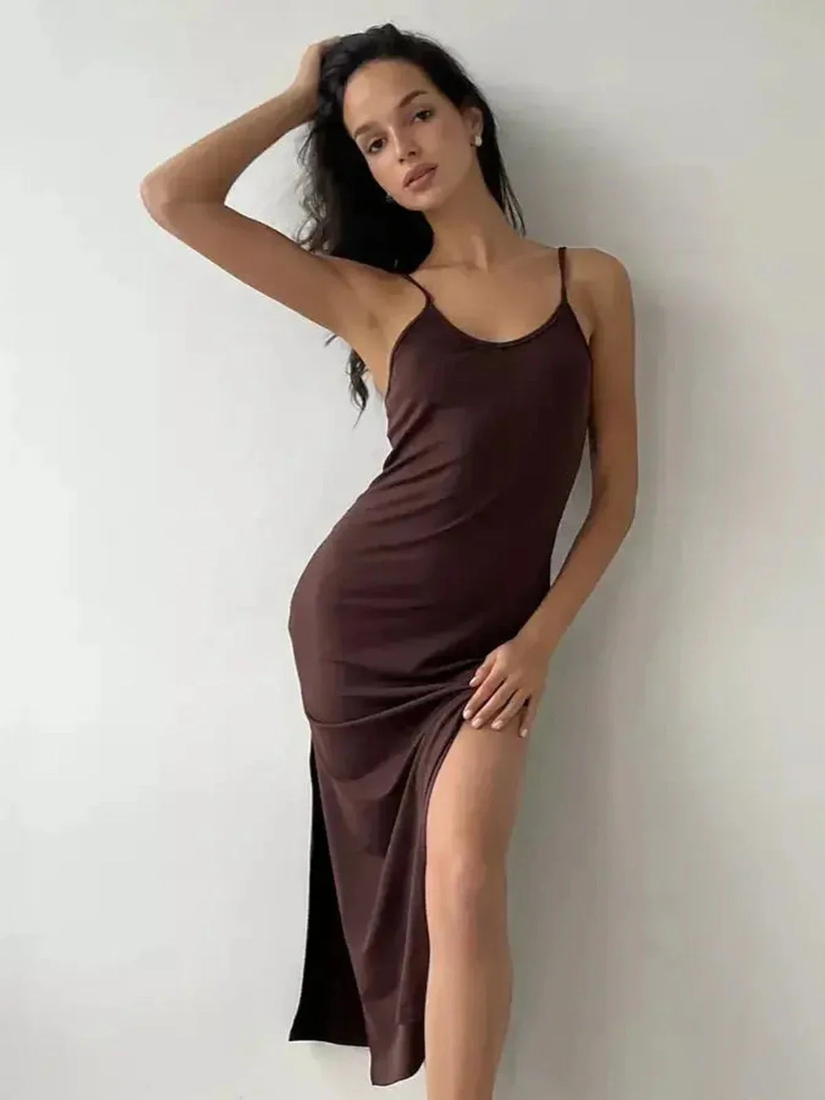 Model wearing a chic Noir Muse Midi Dress in deep chocolate satin with a side slit, perfect for evening events.