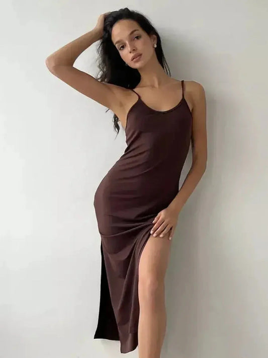 Model wearing a chic Noir Muse Midi Dress in deep chocolate satin with a side slit, perfect for evening events.