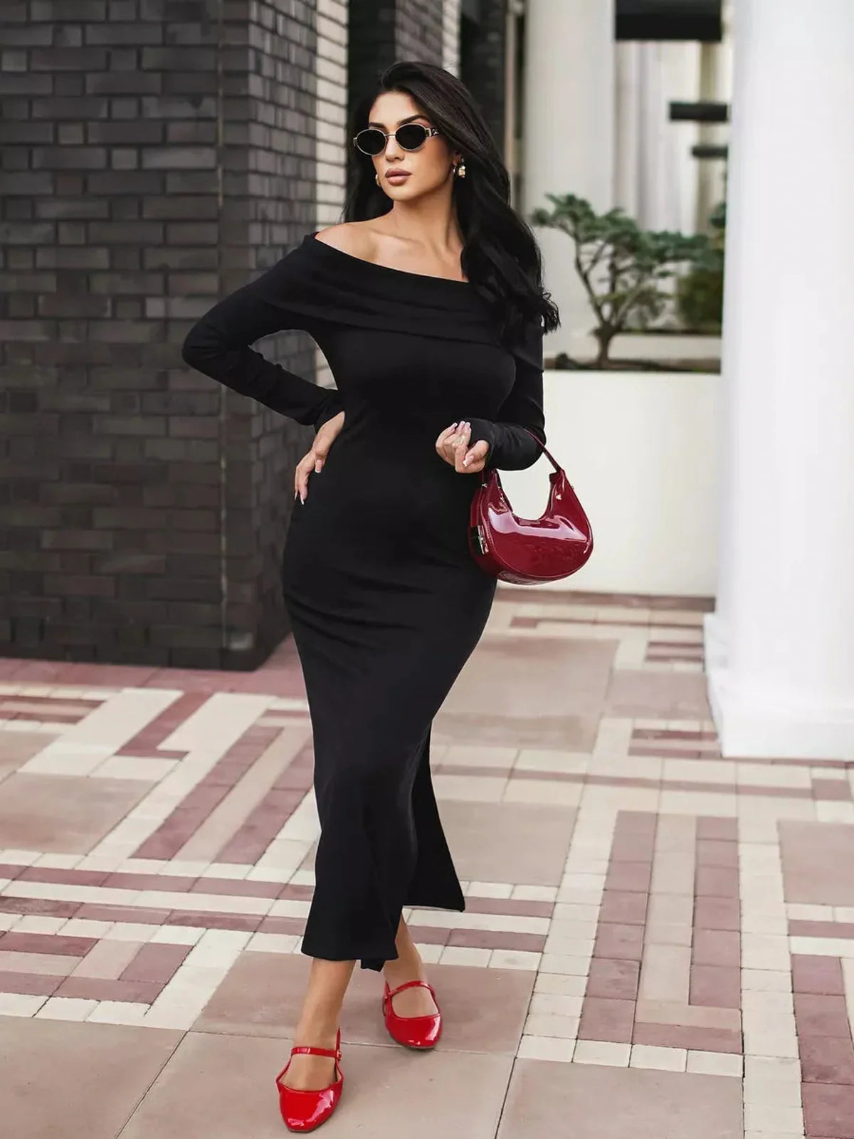 Elegant black off-shoulder maxi dress with flattering slit, perfect for wedding guest, cocktail or formal occasions.