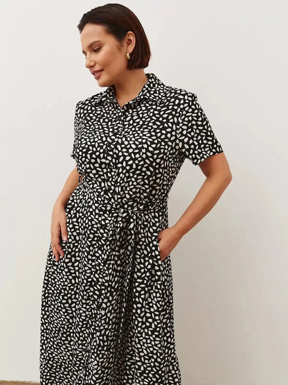 Monaco Midi Dress in black and white print, featuring a flattering shirt-dress silhouette and pockets, perfect for any occasion.