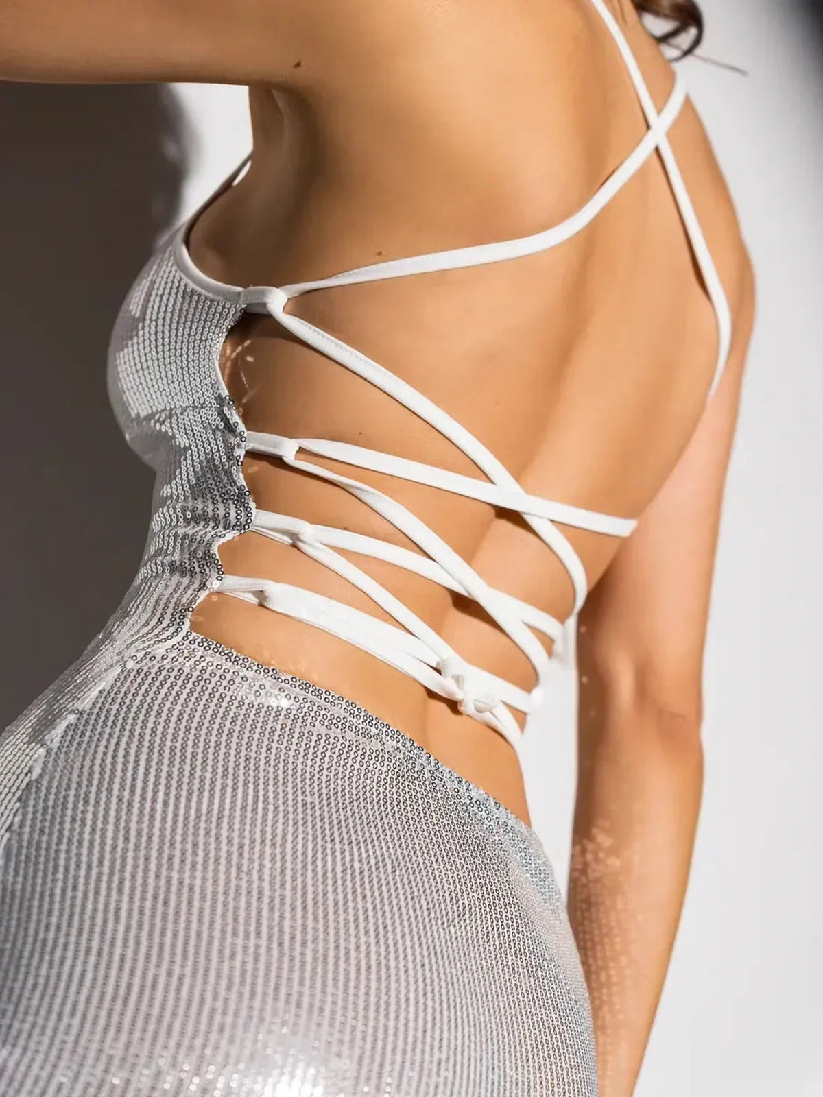 Close-up of the Lustre Midi Dress showcasing its strappy back design and shimmering sequin finish, perfect for weddings.