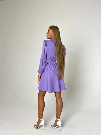 Elegant lavender mini dress, perfect for weddings and special occasions, featuring a cinched waist and long sleeves.