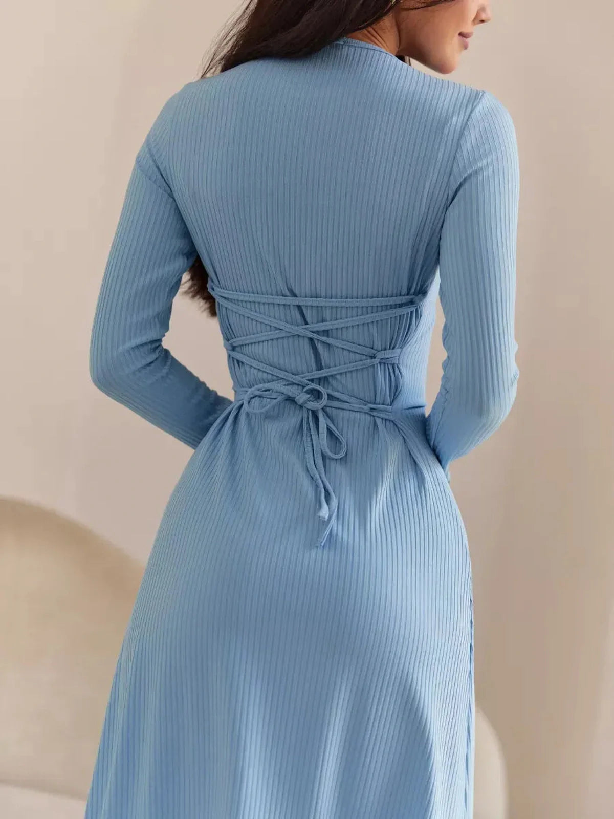 Back view of the Sculpted Grace Midi Dress showcasing elegant corset-style ties and ribbed fabric in soft blue.