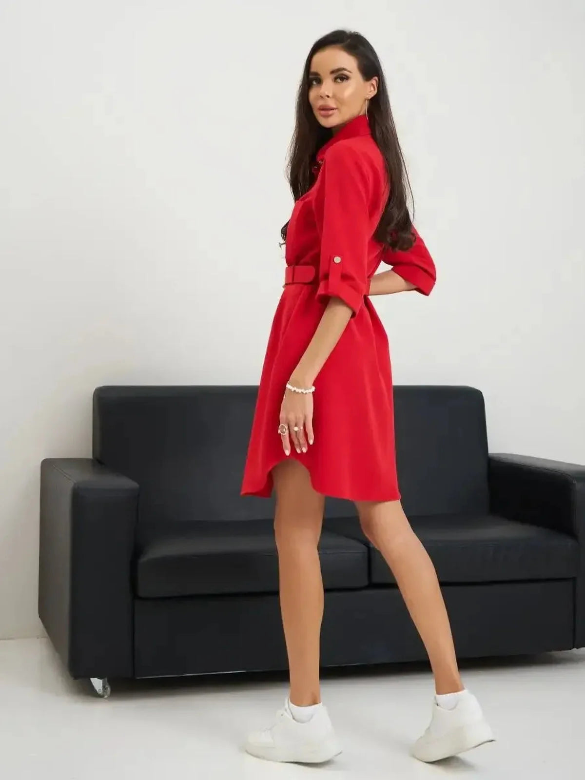 Model showcasing the Scarlet Belted Mini dress in red, featuring a flattering silhouette and stylish belted design.