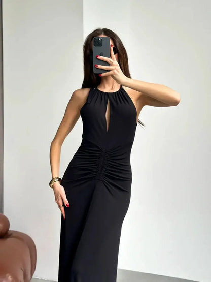Elegant black maxi dress with ruched halter design and front slit, perfect for summer soirées and formal events.