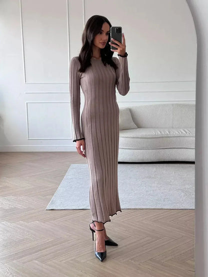 Model showcasing the elegant Contour Maxi Dress, highlighting its ribbed knit, full-length silhouette, and chic style.