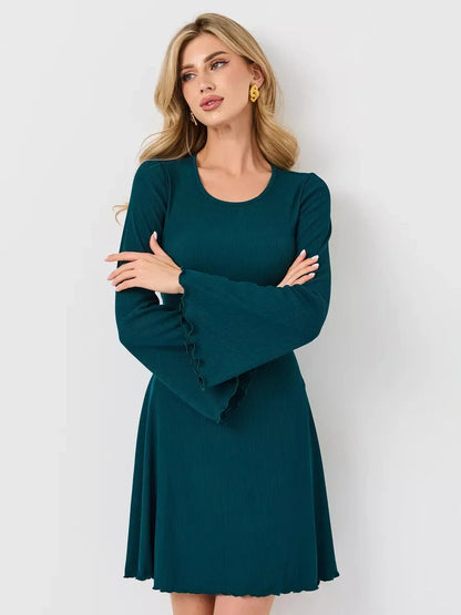 Emerald Whisper mini dress featuring a flared hem and bell sleeves, perfect for weddings and summer events.