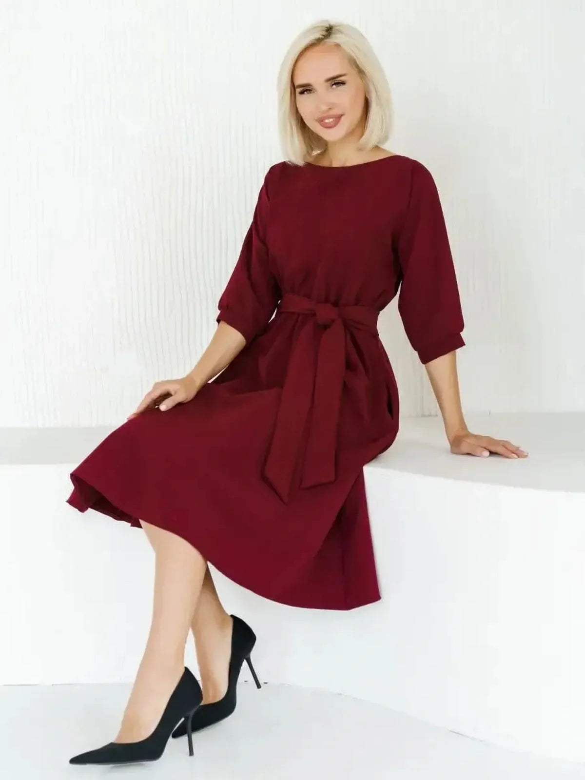 Woman in a burgundy midi dress with a self-tie belt, showcasing elegant style perfect for weddings and formal events.