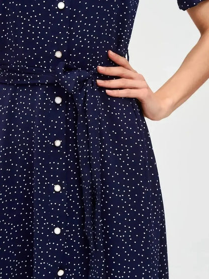 Close-up of the Midnight Dot Midi Dress, showcasing refined navy fabric with white polka dots and a waist-defining belt.