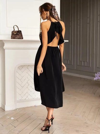 Sleek black Soirée Midi Dress with open back and halter neckline, perfect for summer weddings and formal events.