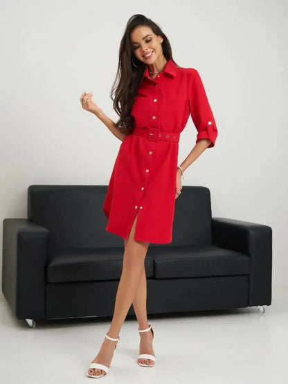 Stylish woman modeling a red belted mini dress, perfect for summer occasions and versatile wardrobe styling.