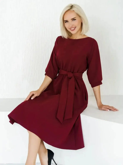 Elegant woman in a crimson midi dress with a self-tie belt, perfect for weddings and formal events.