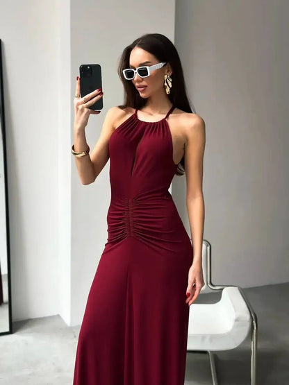Stunning Maxi Dress Élan in burgundy featuring a draped halter design and ruched waist, perfect for evening events.