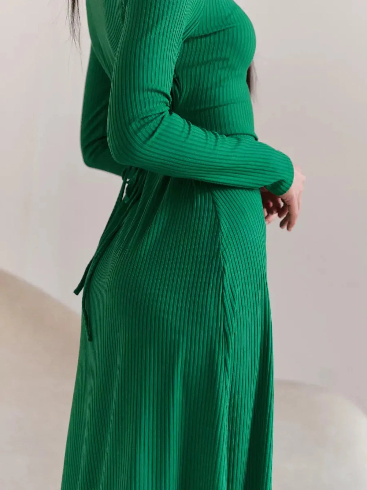 Green Luxe Sculpt Midi Dress featuring a ribbed texture and waist tie detailing for an elegant silhouette.