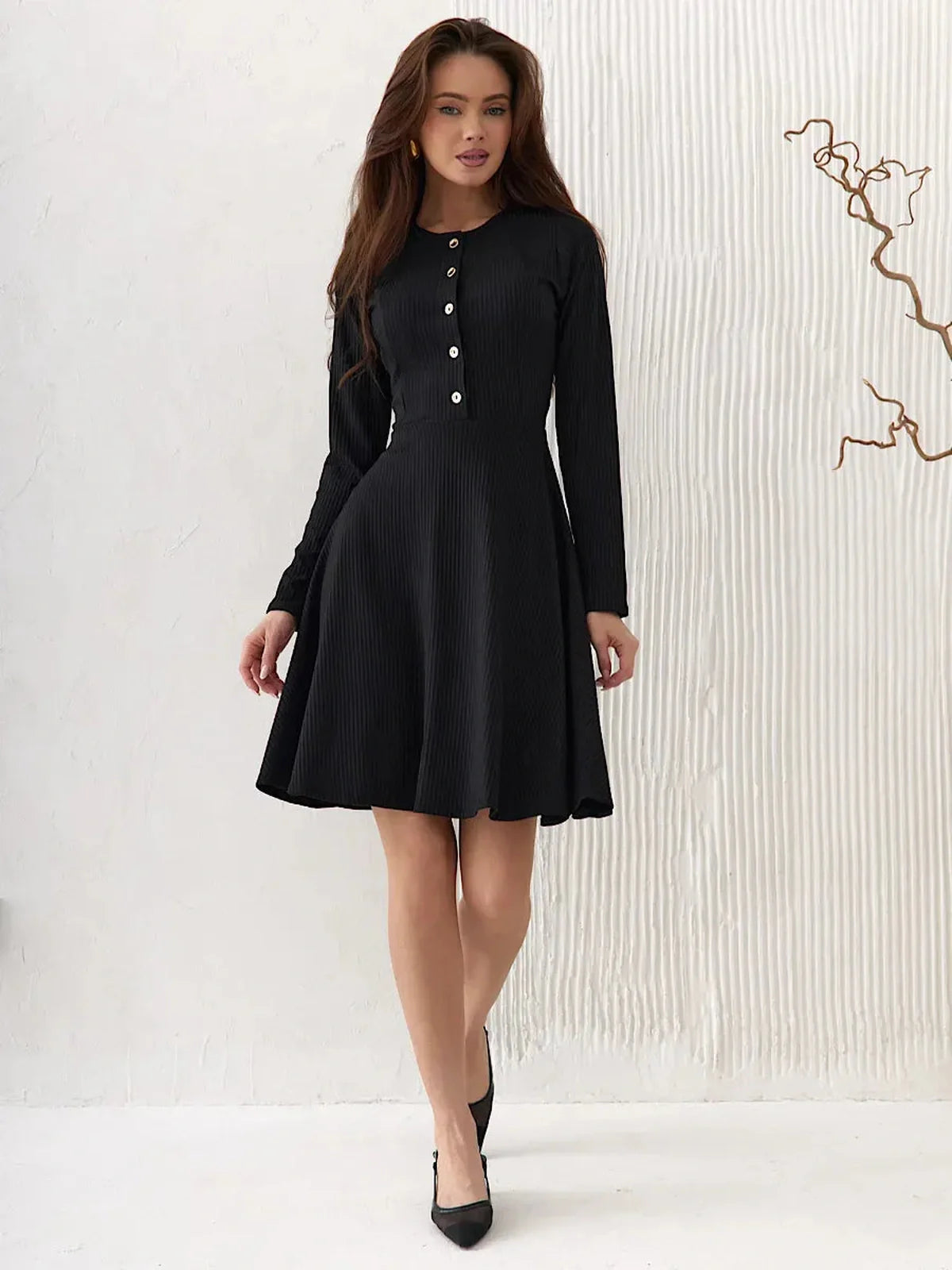 Effortlessly elegant Mod Noir black dress with long sleeves, flattering fit-and-flare cut, and statement buttons.