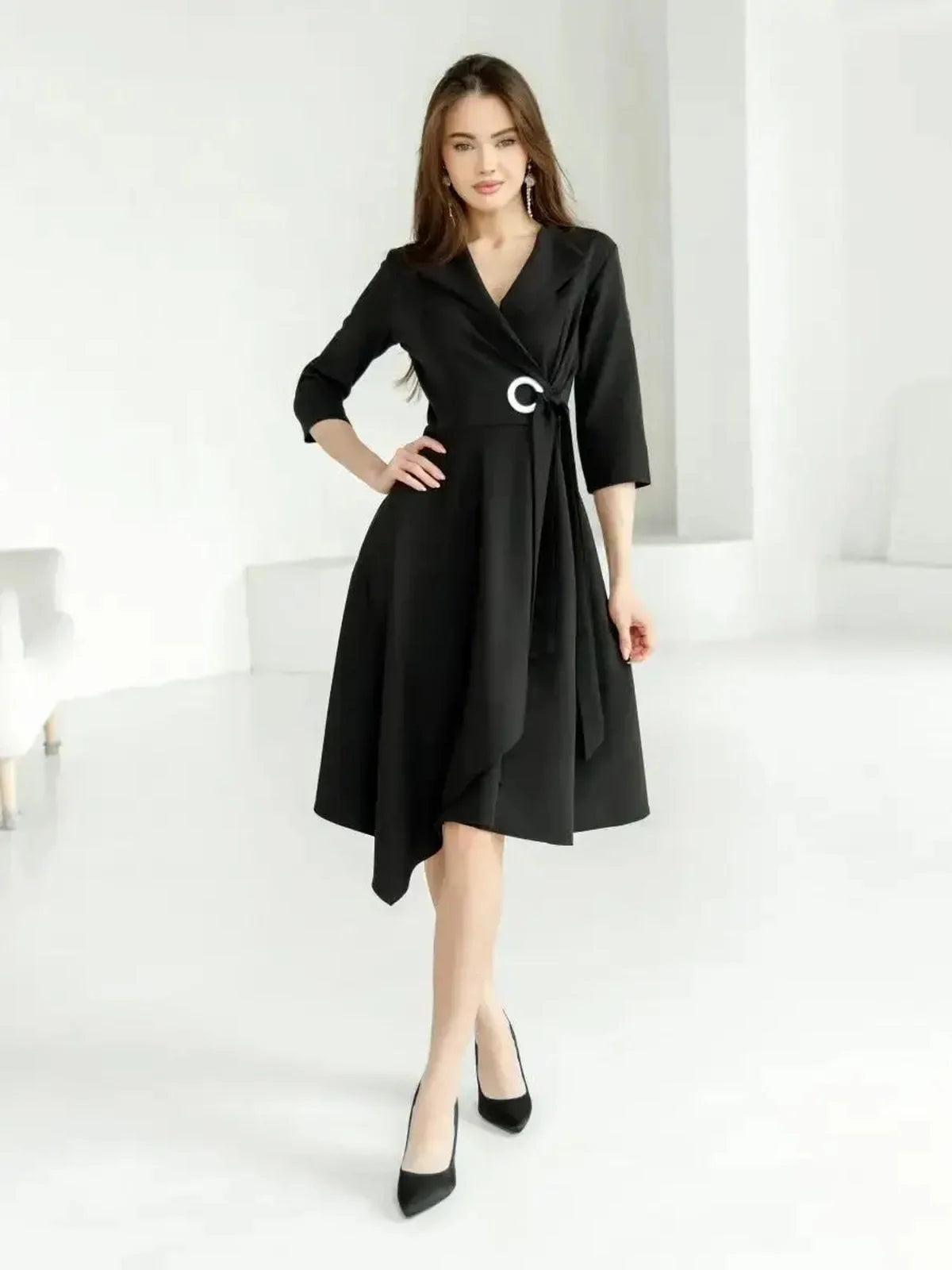 Elegant black midi dress with wrap silhouette and asymmetric hem, perfect for weddings and formal events.