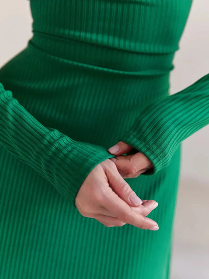 Detail of the Luxe Sculpt Midi Dress showcasing ribbed texture and long sleeves in vibrant green, perfect for chic occasions.