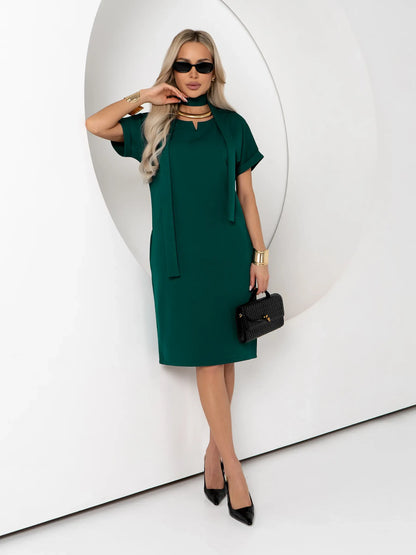 Emerald Mode green mini dress featuring a notched neckline and cuffed sleeves, perfect for summer or formal occasions.