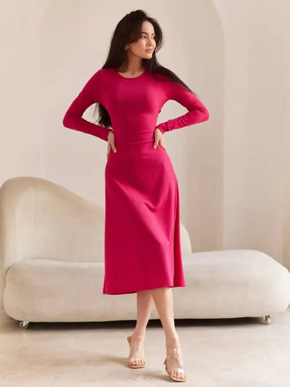 Woman in a pink contour midi dress with long sleeves, showcasing elegance and modern style.