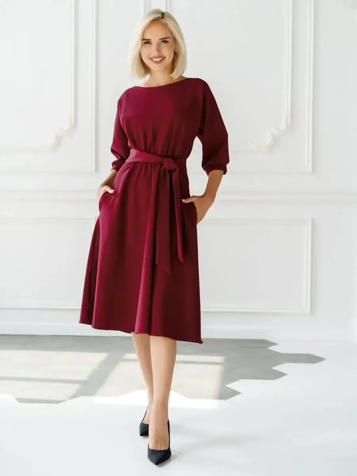 Elegant woman in a crimson midi dress with a self-tie belt, perfect for weddings and formal events.