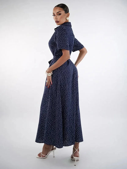 Elegant woman in a navy polka dot midi dress, showcasing a refined silhouette and chic style for versatile occasions.