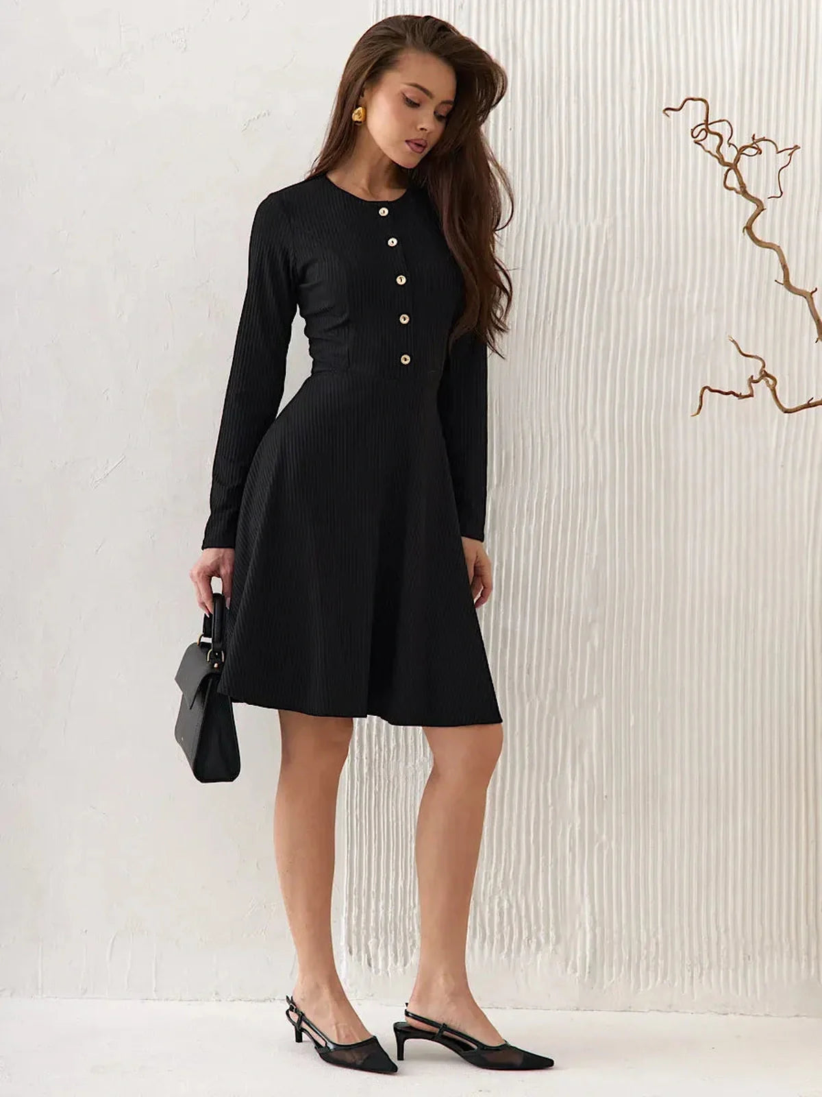 Effortlessly elegant Mod Noir black mini dress with long sleeves, round neckline, and button details, perfect for various occasions.