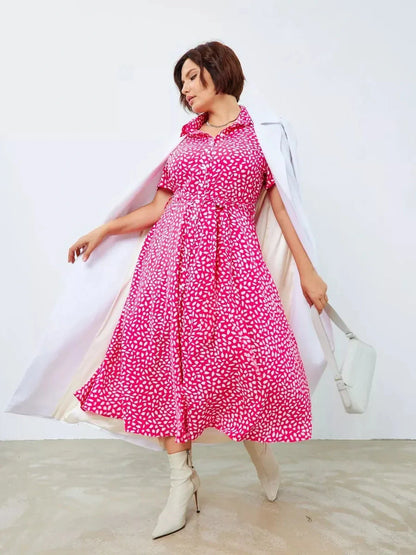 Model wearing the Petal Pop Midi Dress in vibrant fuchsia with abstract white petal print, perfect for summer and special occasions.