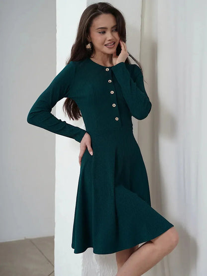 Elegant emerald mini dress featuring long sleeves, ribbed texture, and button placket; perfect for weddings and formal occasions.