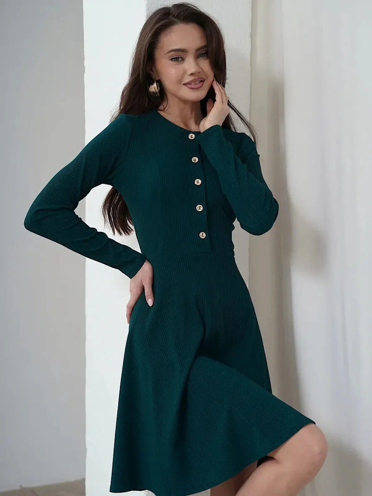 Elegant emerald mini dress with long sleeves, button placket, and flared skirt, perfect for weddings and casual events.