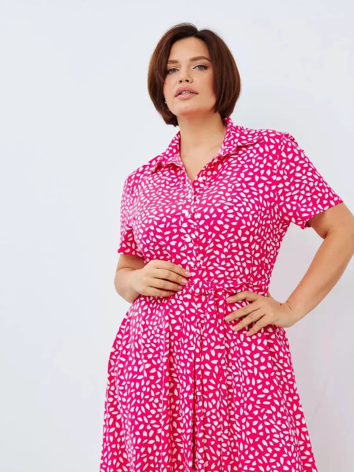 Bold fuchsia Petal Pop Midi Dress with abstract white petals, featuring a button-down front and V-neckline.