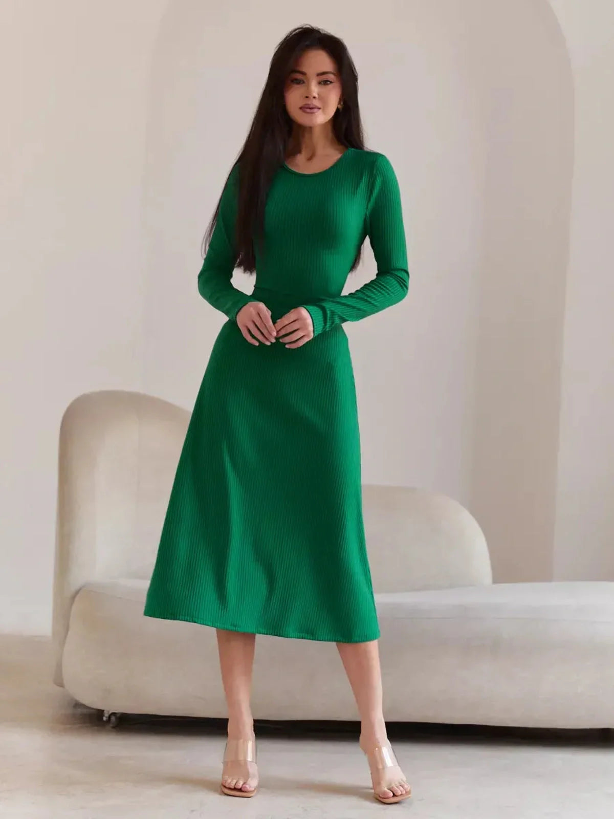 Model wearing a green Luxe Sculpt Midi Dress with ribbed texture, featuring a figure-hugging fit and long sleeves.