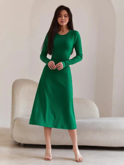 Model wearing a green Luxe Sculpt Midi Dress with ribbed texture, featuring a figure-hugging fit and long sleeves.