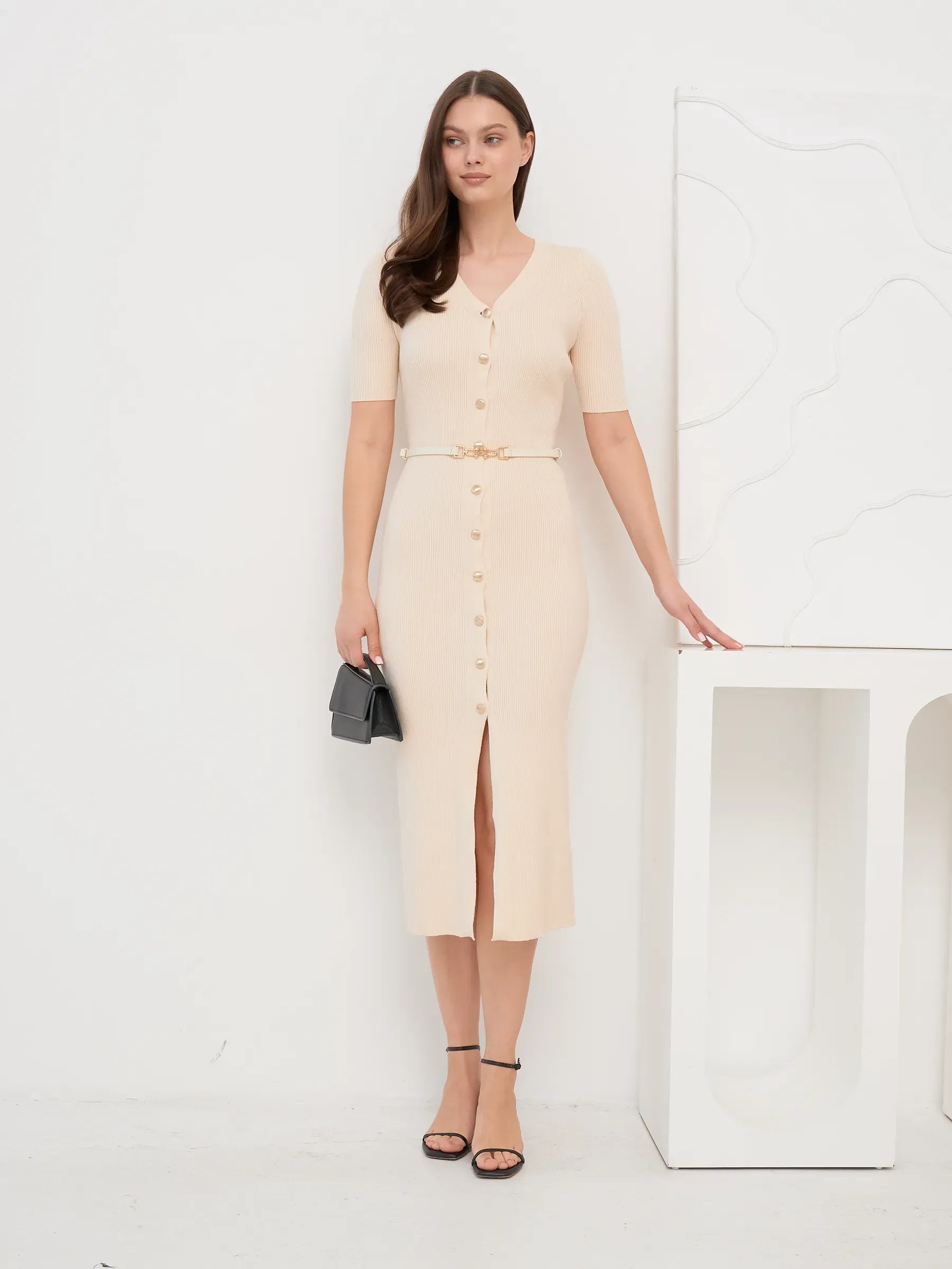 Model wearing Pearl Knit Midi Dress with V-neckline and split hem, ideal for weddings and formal occasions.