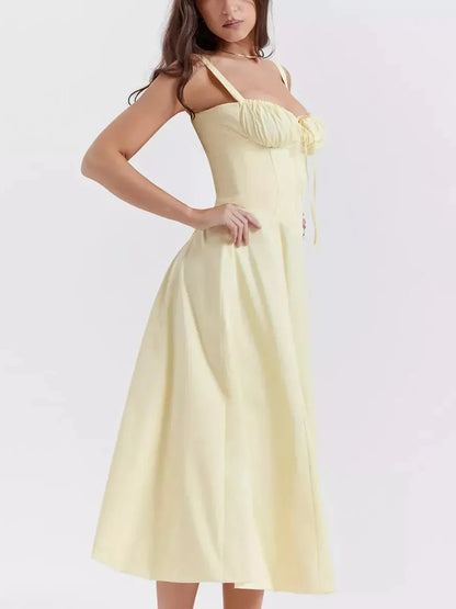 Sunlace Midi Dress featuring a corset detail, softly gathered cups, and flowing A-line silhouette in a light yellow color.
