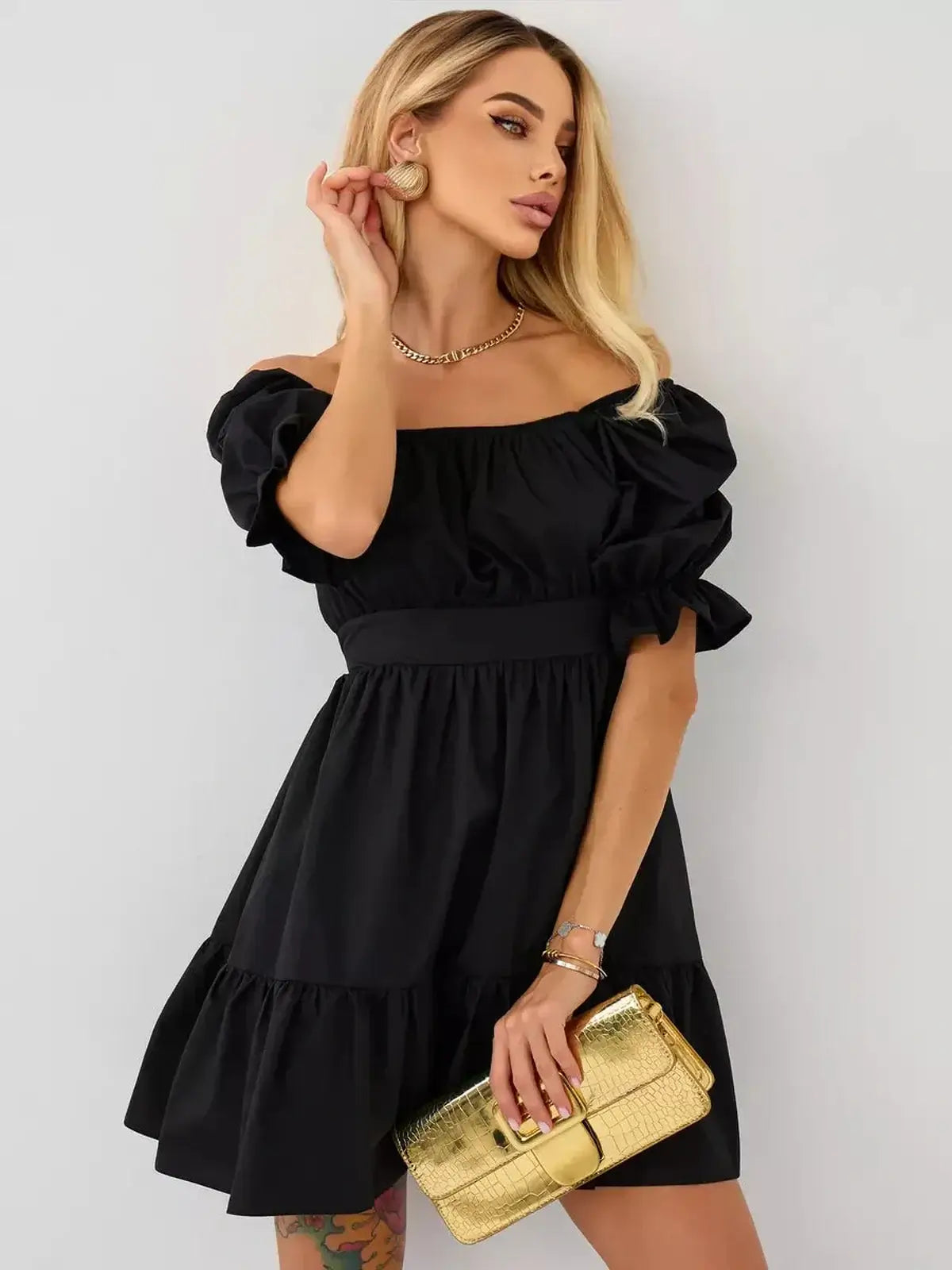 Chic black mini dress with puff sleeves, perfect for summer events and weddings, featuring an elegant off-shoulder design.