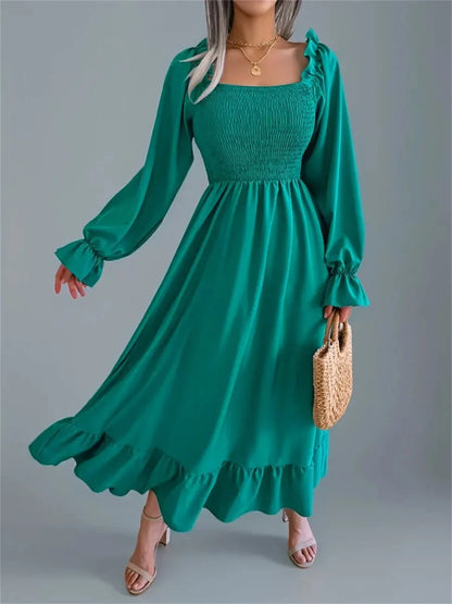 Meadow Ruffle Midi Dress in rich green with long sleeves, smocked bodice, and flowing skirt, perfect for weddings and special occasions.