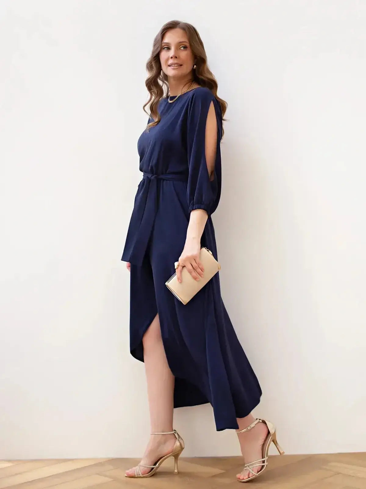 Model wearing the Noir Grace Midi Dress in navy, showcasing elegant cutouts and a fluid silhouette, perfect for formal occasions.