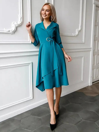 Elegantly dressed woman in a sea wave teal midi dress showcasing a tailored wrap style, perfect for weddings or formal occasions.