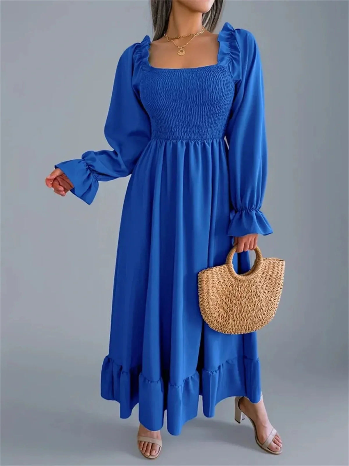 Serena Midi Dress in vibrant blue with smocked bodice, long sleeves, and romantic ruffle details, perfect for weddings and events.
