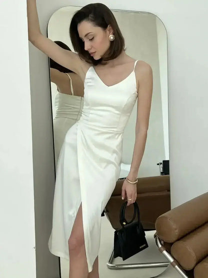Chic model showcasing the Opal Charm Midi Dress in satin with a wrap detail, perfect for weddings or formal events.
