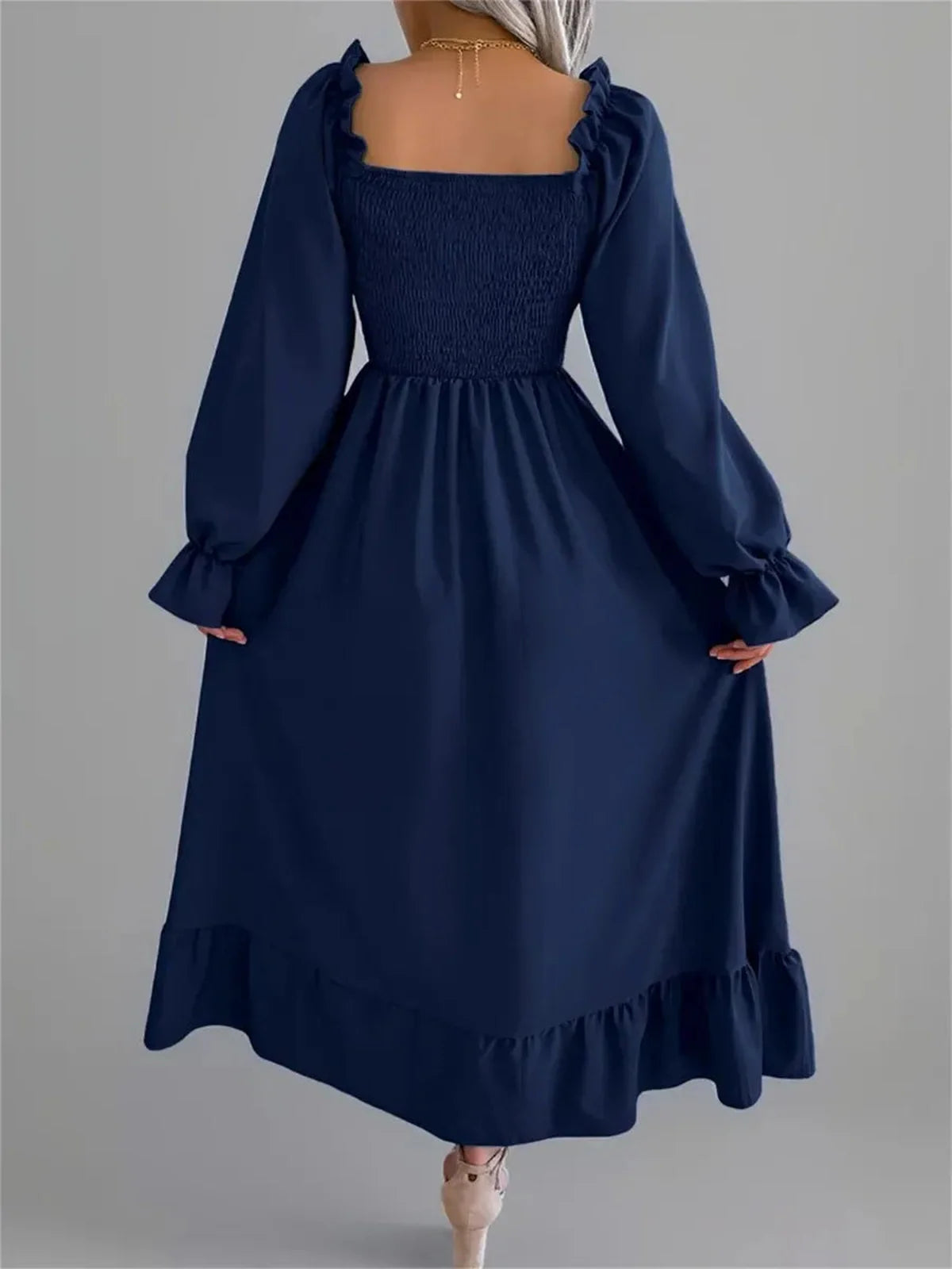 Navy blue midi dress with smocked bodice and flounce hem, featuring long sleeves and a square neckline, ideal for weddings.