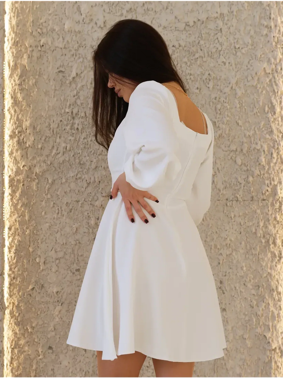 Elegant white dress showcasing a structured design, ideal for wedding guest, graduation, or summer events.