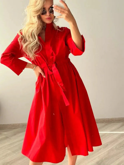 Model showcasing the Crimson Ease Midi Dress in vibrant red, featuring a relaxed silhouette and stylish belt.