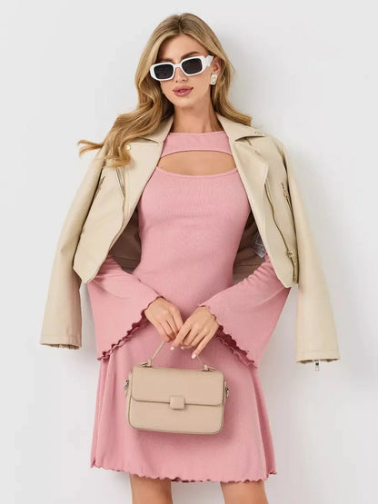 Stylish woman in a pink dress with flared sleeves, wearing sunglasses and a beige jacket, perfect for summer occasions.