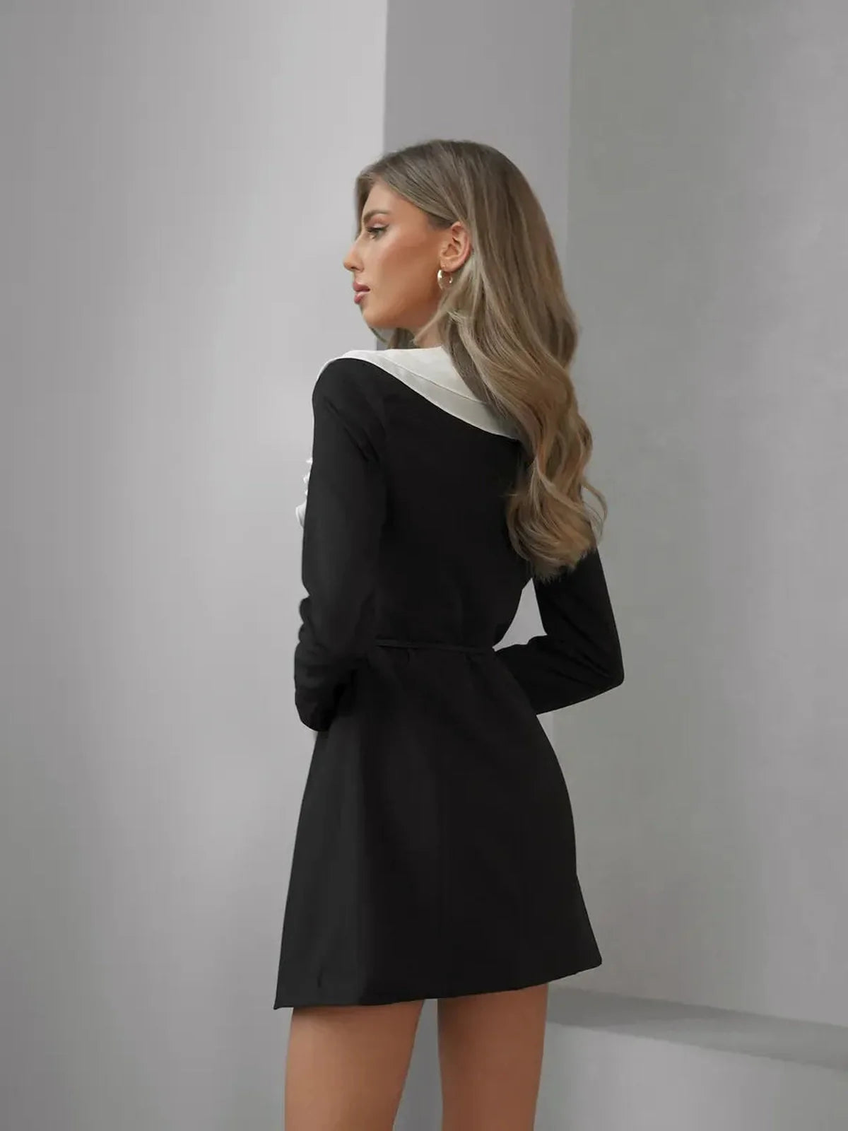 Elegant black mini dress with white ruffled collar, perfect for formal events and chic summer outings.