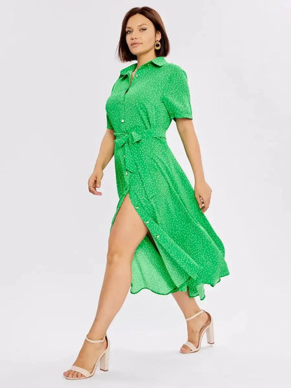 Woman wearing a vibrant green Garden Dot Midi Dress with a button-down front and belt, perfect for summer events.