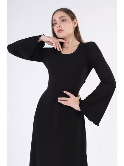 Elegant model showcasing the Noir Flare Midi Dress with bold bell sleeves in classic black.