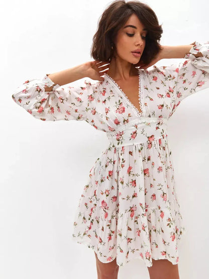 Rose Whimsy Mini Dress featuring a delicate floral print, lace trim, and playful ruffles, perfect for summer celebrations.