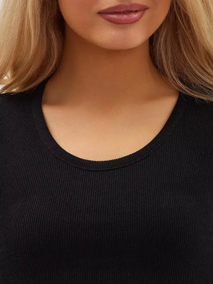 Close-up of a woman's neckline in a black ribbed fabric, showcasing elegance and style in women's clothing.